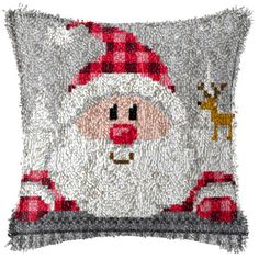 a santa clause pillow with reindeer on it