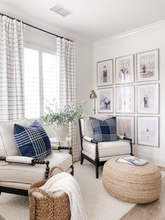 a living room filled with furniture and pictures on the wall