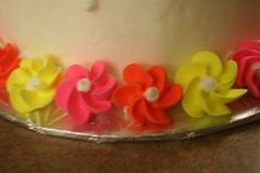 a close up of a cake with flowers on the frosting and icing decoration