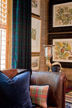 a living room filled with furniture and pictures on the wall