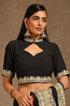 Black saree, accentuated with contrast kashmiri tilla embroidery. Paired with a front cut-out blouse with placement kashmiri tilla embroidery. Components: 2 Pattern: Embroidery Type Of Work: Kashmiri Tilla Neckline: High Neck Sleeve Type: Half Sleeves Fabric: Crepe, Georgette, Lining: Cotton Color: Black Other Details:   Blouse Length: 16 inches Approx. product weight: 2 and 1/2 kg Model height: 5ft 7inches, wearing size S Inner lining Occasion: Sangeet - Aza Fashions Kashmiri Tilla Embroidery, Tilla Embroidery, Embroidered Saree, Black Saree, Pattern Embroidery, Blouse For Women, Saree With Blouse, Blouse Online, Blouse Length