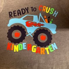 a gray shirt that says ready to crush, and a monster truck on the front