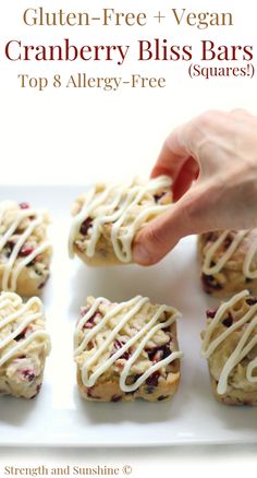 gluten - free vegan cranberry bliss bars on a white plate