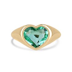 This ring is not for the faint of heart! Displayed is a Colombian emerald bezel-set, chunky signet ring in 18K gold. This gorgeous solitaire ring carries a full 2.19-carat emerald that will have you gazing at its mystic beauty. The emerald is incredibly crystal clear with a stunning freckle imperfection that adds the cutest beauty mark to this natural stone. This emerald will have you captivated at first glance.  Setting Style: Bezel-Solitaire Setting Material: Yellow Gold 18K Setting Weight: 4.2 Grams Main Stone: Emerald  Shape: Heart  Weight: 2.19-Carats Clarity: Transparent Color: Bluish Green Luster: Excellent Treatments: Natural, Oiling Origin: Colombia   Estimated Retail Value: $16,490.00 USD A certificate of appraisal is provided upon purchase. Keep in mind we custom create all of t Fine Jewelry Green Heart Shaped Ring, Green Heart-shaped Fine Jewelry Ring, Green Heart Ring For Anniversary, Green Heart-shaped Emerald Ring For Anniversary, Heart-cut Emerald Ring For Formal Occasions, Heart Cut Emerald Ring For Formal Occasions, Emerald Heart-shaped Anniversary Rings, Emerald Heart Shaped Anniversary Rings, Heart Cut Green Emerald Ring