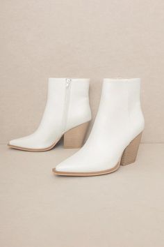 Introducing the one-of-a-kind Andie Western Ankle Boots to elevate your wardrobe with a timeless nod to western fashion. Length: 8.5" Heel Height: 3.5" Material Composition: ARTIFICIAL LEATHERCare Instructions: HAND WASH Western White Boots With Stacked Heel, White Western Heeled Boots For Fall, Trendy White Square Toe Heeled Boots, White High Heel Boots For Spring, Trendy White Heeled Boots For Fall, White High Ankle Boots With Sculpted Heel, White Western Ankle Heeled Boots, White Ankle-high Heels For Fall, Fitted White Heeled Boots With Reinforced Heel