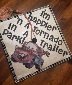 a decorated graduation cap that says i'm happy in a tornadoo park trailer