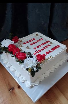 a white cake with red roses on it