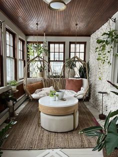 a living room filled with furniture and lots of plants