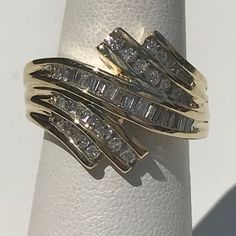 a gold ring with three rows of diamonds