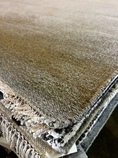 a close up view of an area rug with fringes on the bottom and sides