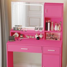 a pink desk with a mirror and makeup on it