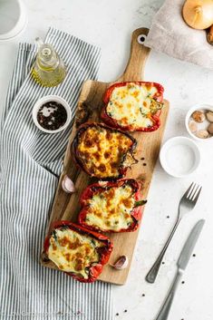 stuffed bell peppers on a wooden cutting board