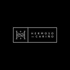 the logo for hermoso - carino is shown in black and white on a dark background