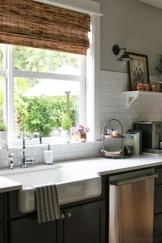 a kitchen with a sink, dishwasher and window