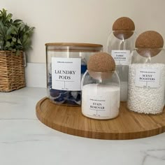 there are three jars on the counter with soaps and bath salts in them next to each other