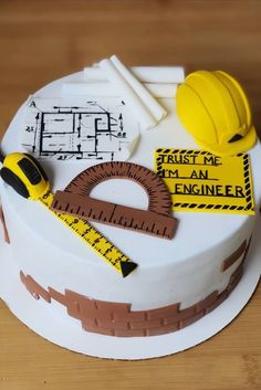 a cake decorated with construction tools and tape measure