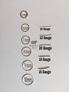 some type of magnets that are on a white surface with measurements for each one