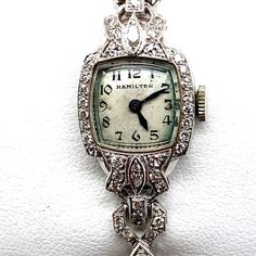 Vintage white gold and diamond Hamilton women's watch. This watch is 14k and contains about .50cts of diamond. This watch has a mechanical movement, runs and keeps great time. Like all of our watches, this also comes with a 1-year guarantee and a 7day return policy that applies to all listings. Thank you for your time and feel free to reach out with any questions! Luxury Vintage Collectible Watch Accessories, Luxury Vintage Jewelry And Watches With Polished Finish, Luxury Antique Watch Accessories For Formal Occasion, Diamond Watches With 17 Jewels For Evening, Vintage Formal Watches With Brilliant Cut, White Gold Diamond Watch With Single Cut Diamonds, Evening Diamond Jewelry With Brilliant Cut, Brilliant Cut Diamond Jewelry For Evening, Art Deco Diamond Watch With Round Shape