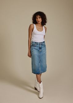 The Abbey midi skirt is a classic denim mid-length skirt perfect for any occasion. This slightly longer skirt style sits at the hips and has a slight a-line to the opening. Easy to accessorize with a simple t-shirt or button down and sandals, heels or your favorite cowboy boots.  Rise Mid-Rise Responsible Designed in LA and responsibly made on imported materials Long Skirt Fashion, Simple T Shirt, Stylish Skirts, Ethical Brands, Skirt Style, Fashion 101, Mid Length Skirts, Ethical Clothing, Sustainable Clothing