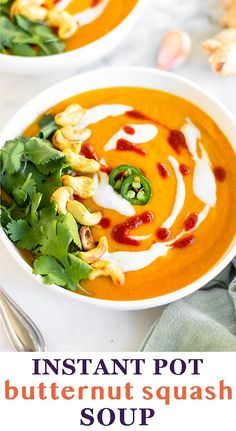 two bowls filled with carrot soup and garnished with cilantro