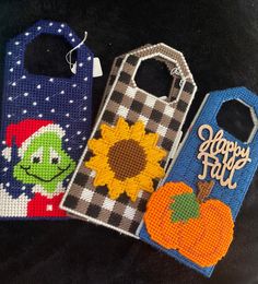 three handbags with designs on them sitting next to each other, one has a happy fall tag and the other has a sunflower