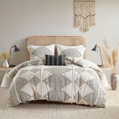 a bed with white and black comforter in a bedroom