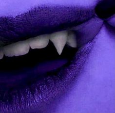 a woman's purple lips with white teeth