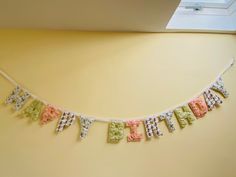 a happy birthday banner hanging on the wall