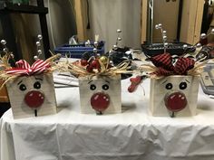 three bags with reindeer faces are sitting on a table