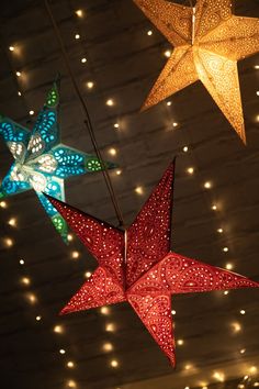 three star shaped lights hanging from the ceiling