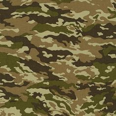 camouflage print fabric in brown, green and tan colors with a ruler on the side