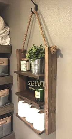 a wooden shelf holding toilet paper and plants