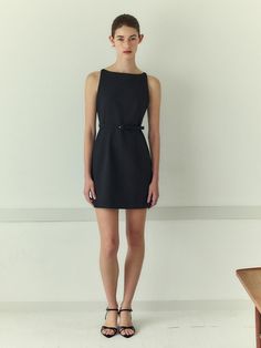 This elegant sleeveless dress showcases a refined design with its structured fit and minimalist style. It features a square neckline that lends a modern edge, complemented by precise darting at the bust and waist to enhance the silhouette. A slim, detachable belt with a subtle buckle accentuates the waist, offering a tailored look. The dress is secured with a concealed zipper at the back, ensuring a sleek and uninterrupted profile.- The square neckline and structured darts create a sophisticated and contemporary appearance, suitable for professional and formal settings.- The inclusion of a detachable belt allows for versatility in styling, providing an option to either emphasize the waist or opt for a more streamlined silhouette without the belt.- Its solid color and classic design make it Elegant Sleeveless H-line Evening Dress, Modern H-line Party Dress, Cocktail Mini Dress With Structured Boning, Sleeveless, Structured Sleeveless Formal Dress, Chic Structured Sleeveless Midi Dress, Elegant Sleeveless Mini Dress For Work, Chic Tailored Sleeveless Dress, Classic Tailored Dresses With Structured Boning, Classic Tailored Dress With Structured Boning