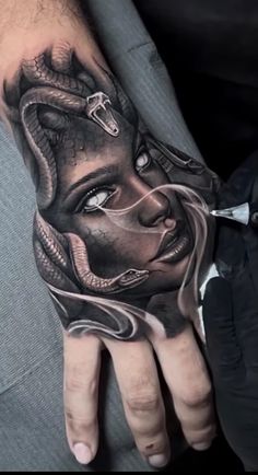 a person's hand with a tattoo on it and a woman's face