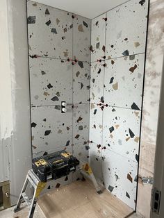 a room that has some kind of wallpaper on it, and is being worked on