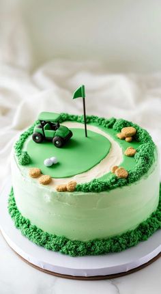 a cake with green frosting and a golf ball on top