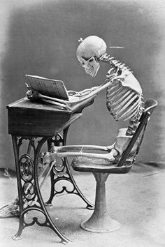 a skeleton sitting at a sewing machine with a laptop on it's lap top