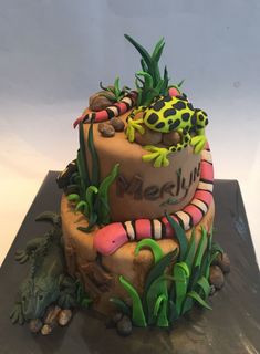 there is a cake decorated with animals and plants