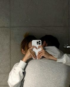 a person taking a selfie in front of a mirror with their cell phone up to their face