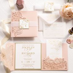 the wedding stationery is laid out on top of each other, including pink and gold