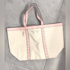 Victoria’s Secret Oversized Canvas Tote Bag New With Tags. Looks Little Wrinkled-From Being Fold Up In Shipping Bag. Plastic Still Attached On Handles+Tag. Light Ivory+Pink W/Gold Metal Studs On The Front. Victoria’s Signature Inside Bag. Very Thick/Heavy Canvas Tote. Will Be Posting More Totes, Bags And Purses Soon. I’m Not Able To Carry This Size Due To Spinal Surgeries And Foot Surgeries . Check Back Daily/Weekly For New Update If Interested. -Great For Travel!! -Work -School -Gym -Beach -Mor Victoria's Secret Large Travel Bag, Victoria's Secret Large Capacity Travel Bag, Elegant Victoria's Secret Tote Shoulder Bag, Victoria's Secret Travel Tote Bag, Victoria's Secret Pink Tote Bag, Inside Bag, S Signature, Folded Up, Victoria's Secret