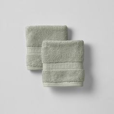 two light green towels sitting on top of each other