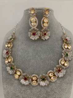 Floral Pattern Multi Stone Kundan Dual Tone Finish Neckline Necklace with Matching EarringsColor : GoldenSize : Necklace Length : Approx 16 Inches; Earring Length : 2.25 InchesStones : Kundan, Multi Stone Multicolor Hand Set Bridal Necklace, Hand Set Multicolor Bridal Necklace, Formal Multicolor Hand Set Necklace, Multicolor Hand Set Bridal Necklace For Party, Multicolor Kundan Necklace With Matching Earrings, Elegant Multicolor Kundan Necklace With Stones, Formal Multicolor Necklace With Matching Earrings, Formal Multicolor Necklaces With Matching Earrings, Multicolor Round Jewelry Sets For Formal Occasions