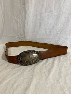 "Measurements in inches: Long: 46\" Deep: 1\"7 First perforation from buckle is 34\" and 40\" on the last Buckle measurements W: 5 H: 3\"2 Condition: -Good Pre-owned condition for its age -Buckle shows normal sings or wear from use -Belt is clean Shipping: -All purchases are sent within 1-2 business days -I send all the domestic purchases via USPS Priority mail and include a tracking number (emailed upon request). If you need an extra service please request it once you purchase your item -For in Classic Antique Belt Buckles For Ranch, Leather Concho Belt Buckles For Formal Wear, Formal Leather Concho Belt, Western Leather Belts And Suspenders With Antique Buckle, Vintage Formal Belts With Silver Buckle, Vintage Silver Leather Belt Buckles, Vintage Leather Belts For Ranch, Formal Brown Concho Belt Buckles, Vintage Brown Belt Buckles With Silver Buckle