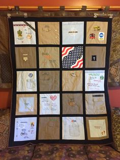 a quilt made to look like an american flag with many different patches and words on it