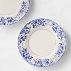 two blue and white plates sitting next to each other