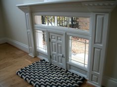 a dog mat is on the floor in front of an open window with doors and windows