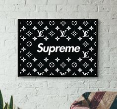 a black and white wall hanging above a chair with the word supreme written on it