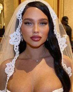 a woman wearing a wedding veil and bridal gown