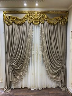 an ornate gold and white curtain in the corner of a room